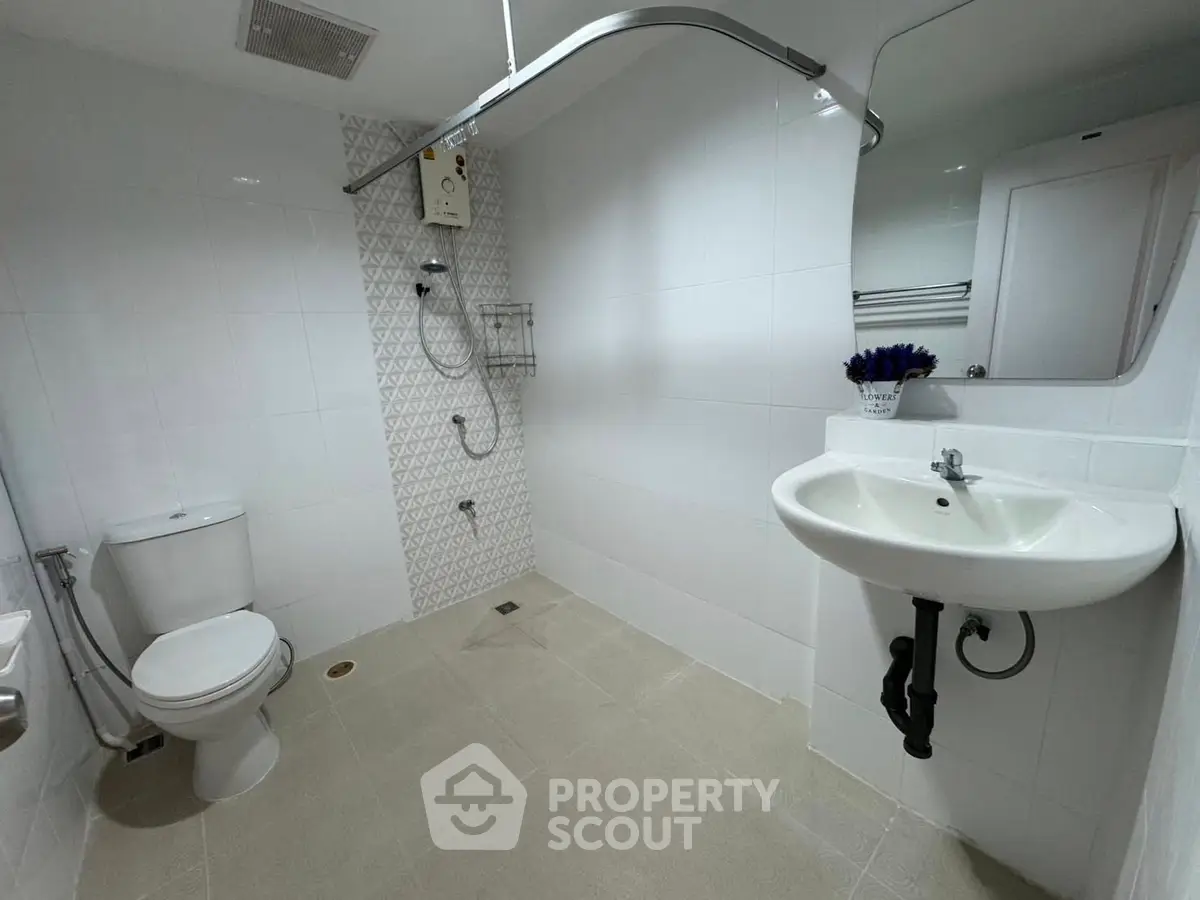 Modern bathroom with sleek white tiles and stylish fixtures