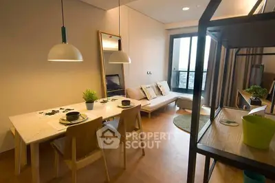 Modern living room with dining area and large window in stylish apartment.