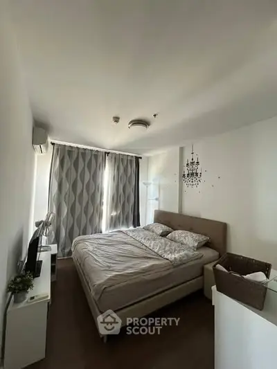 Cozy bedroom with modern decor and large window for natural light