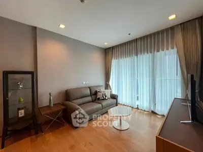 Modern living room with sleek furniture and large window drapes