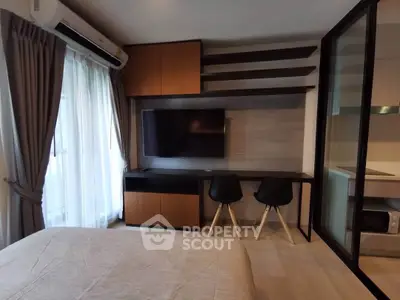 Modern bedroom with wall-mounted TV and stylish workspace