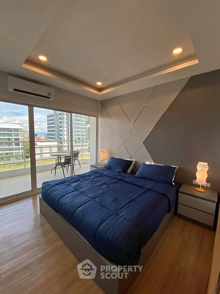 Modern bedroom with large windows and balcony view in a stylish apartment