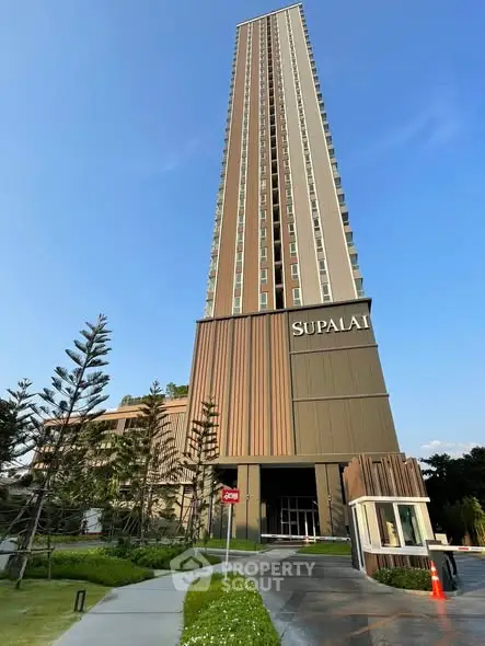 Stunning high-rise building exterior with modern architectural design and lush landscaping.