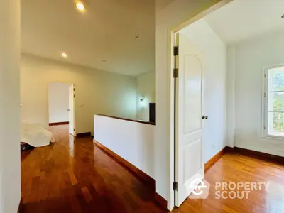 Spacious interior with wooden flooring and natural light, ideal for modern living.