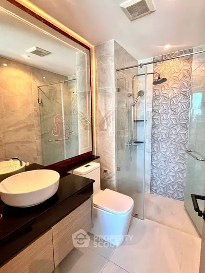 Modern bathroom with elegant fixtures and glass shower enclosure
