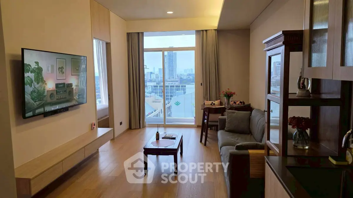 Modern living room with city view, wooden flooring, and sleek furniture