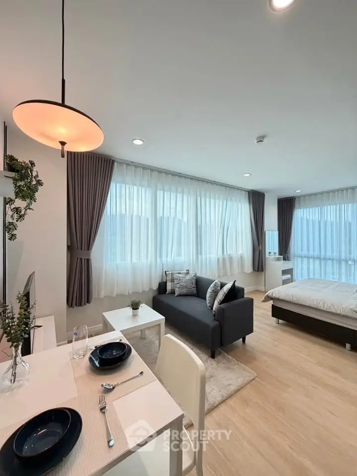 Modern open-plan studio with stylish decor and ample natural light