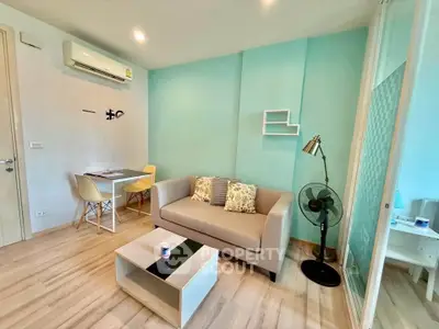 Modern living room with stylish decor and cozy seating in a bright apartment.