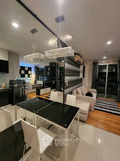 Modern open-plan living and dining area with stylish decor and large windows.