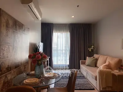 Cozy living room with elegant decor and natural light, featuring a stylish sofa and dining area.