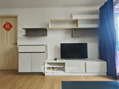 Modern living room with stylish TV unit and wall shelves, featuring elegant wooden flooring and a cozy ambiance.