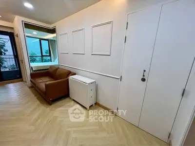 Modern living room with sleek design and natural light, featuring a cozy sofa and stylish flooring.