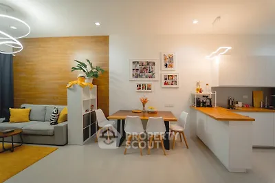 Modern open-concept living and dining area with stylish decor and warm lighting.