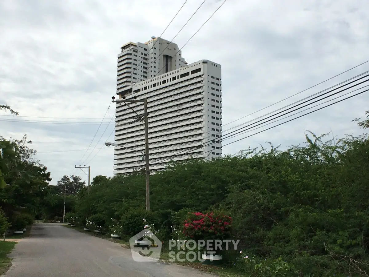 Stunning high-rise building with lush greenery and clear sky view
