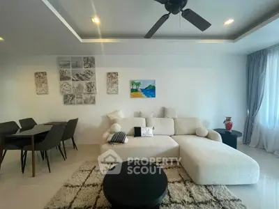 Modern living room with cozy sectional sofa and elegant dining area, perfect for stylish urban living.
