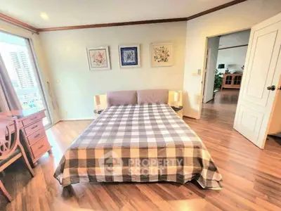 Spacious bedroom with stylish decor and city view, perfect for modern living.