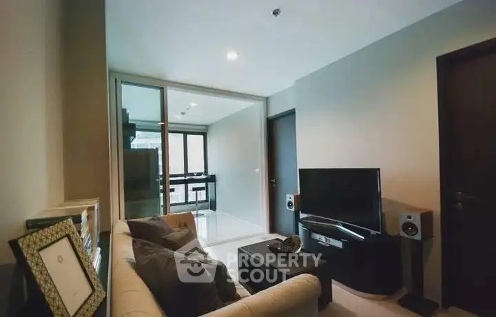 Modern living room with sleek TV setup and cozy seating area