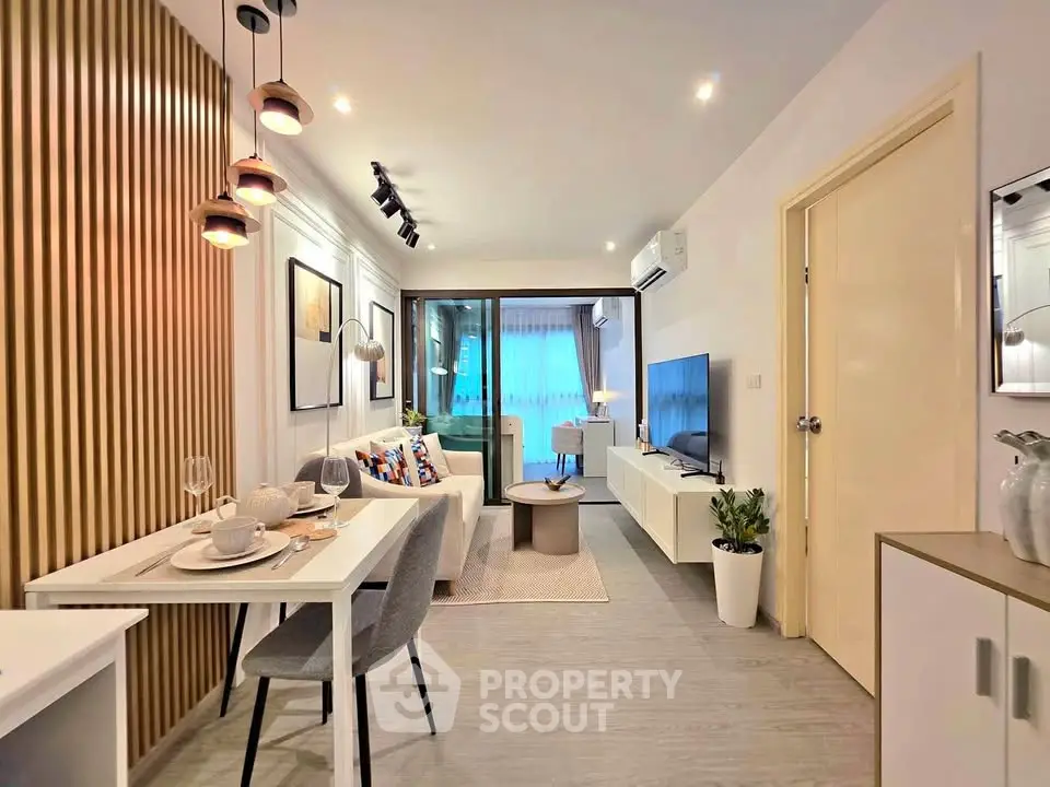 Modern living room with stylish decor and open layout, featuring a cozy dining area and large windows.