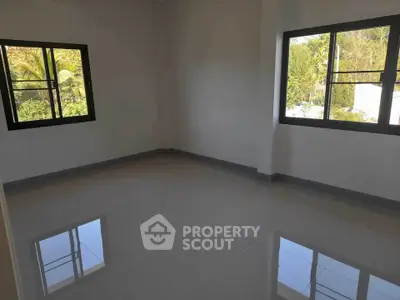 Spacious empty room with large windows and glossy tiled floor, perfect for customization.