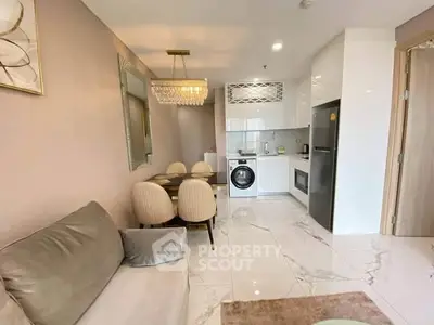 Modern open-layout kitchen and living room with elegant decor and appliances