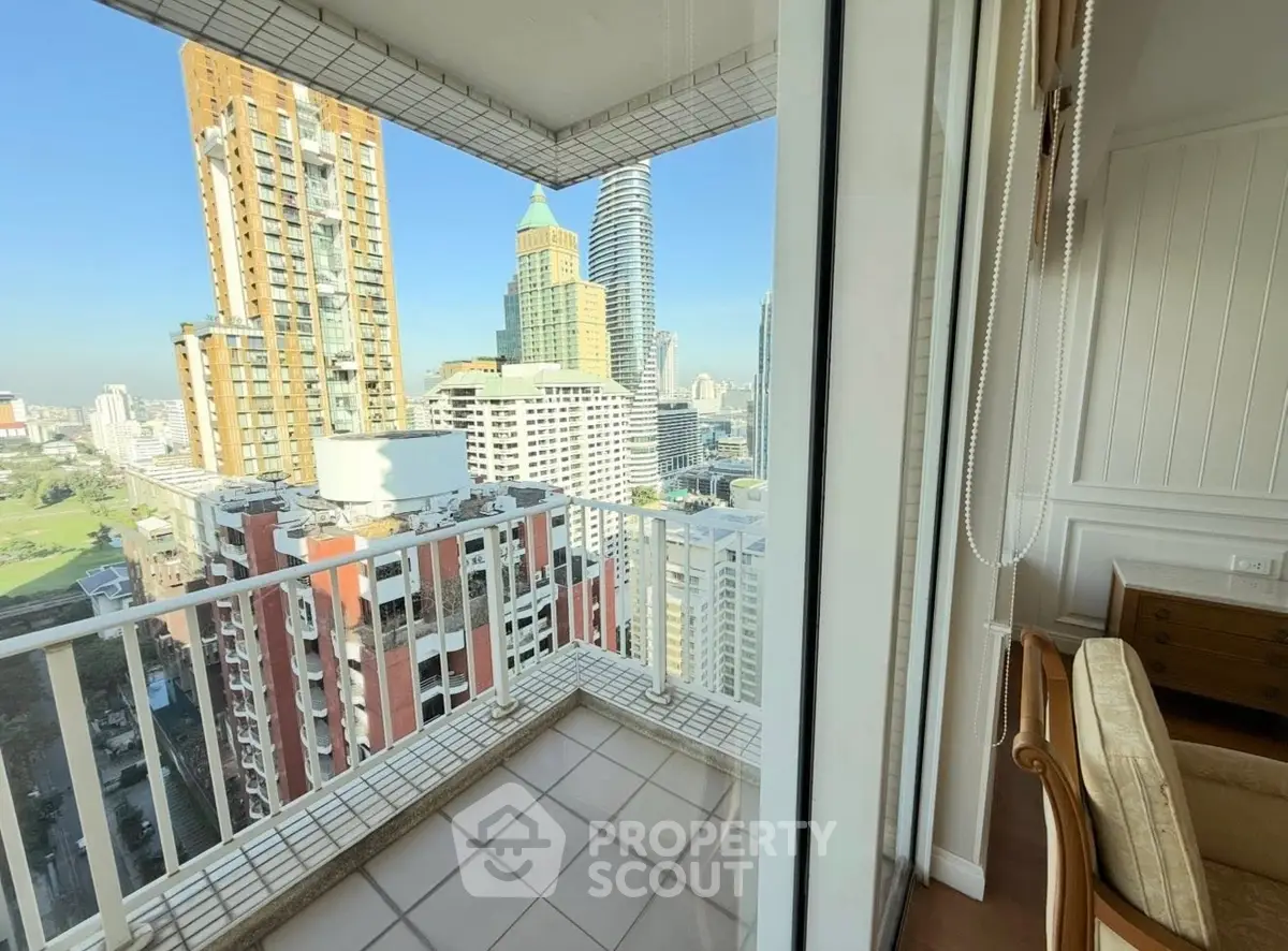 Stunning city view from high-rise balcony with modern urban skyline.