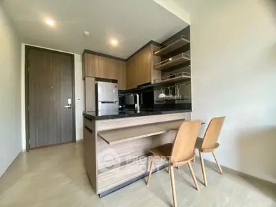 Modern kitchen with sleek wooden cabinetry and stylish bar seating