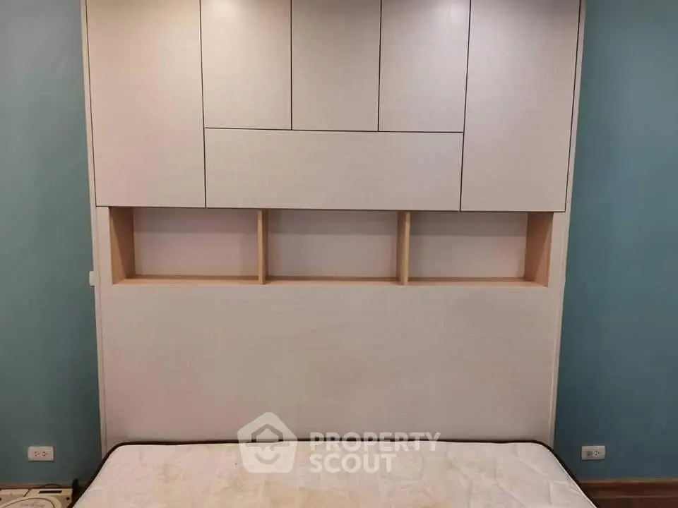 Modern bedroom with built-in storage and stylish headboard design