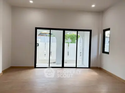 Spacious living room with large sliding glass doors and natural light