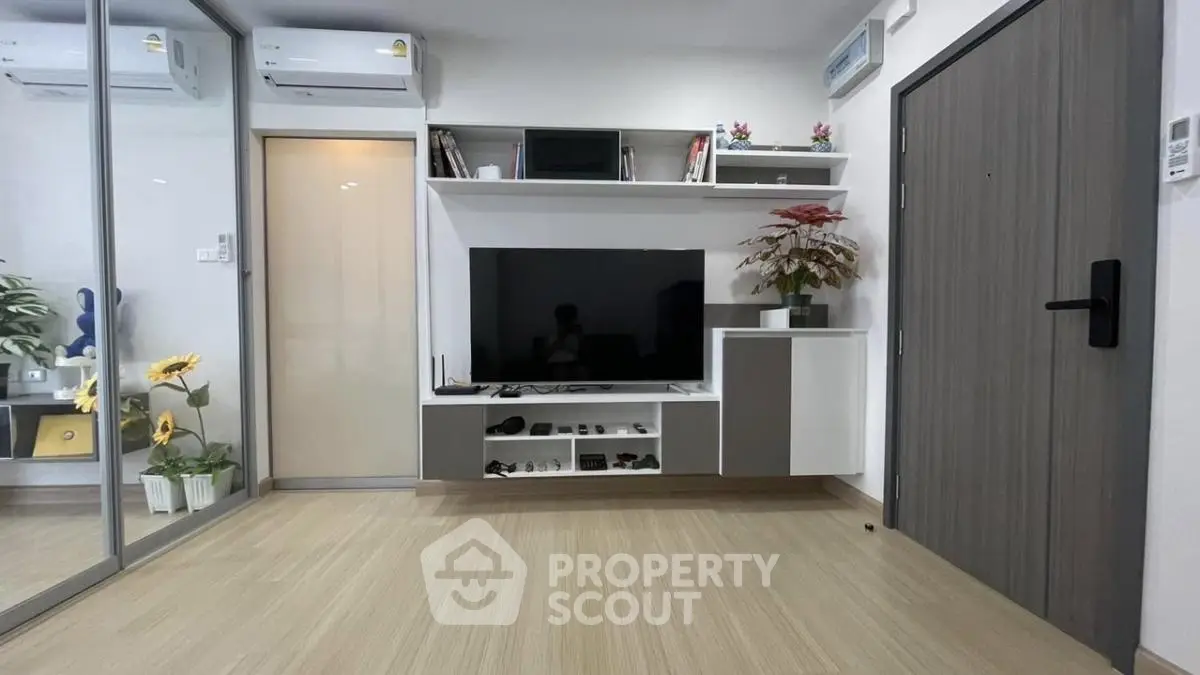 Modern living room with sleek TV unit and mirrored wardrobe