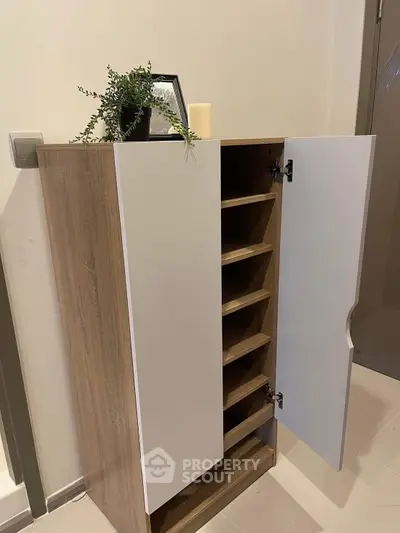 Modern wooden storage cabinet with open shelves and decorative plant