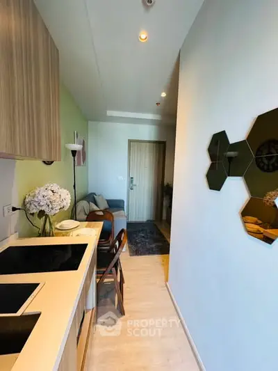 Modern compact kitchen with open layout and stylish decor in a cozy apartment.