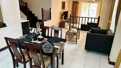 Spacious living and dining area with elegant decor and natural light.