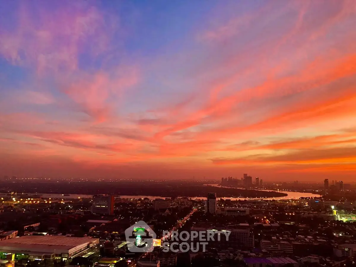 Stunning cityscape view with vibrant sunset sky over urban skyline.