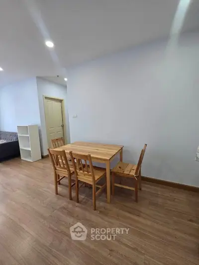 Cozy dining area with wooden table and chairs in modern apartment