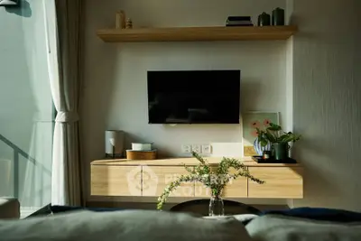 Modern living room with wall-mounted TV and stylish wooden shelves