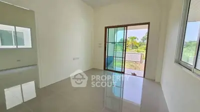 Bright and airy room with sliding glass doors leading to a lush garden view, perfect for relaxation.