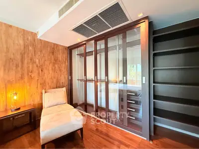 Luxurious bedroom with elegant wooden flooring and modern glass wardrobe