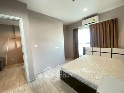 Modern bedroom with natural light and stylish decor in a cozy apartment.