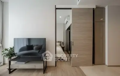 Modern apartment with sleek sliding door and stylish TV setup