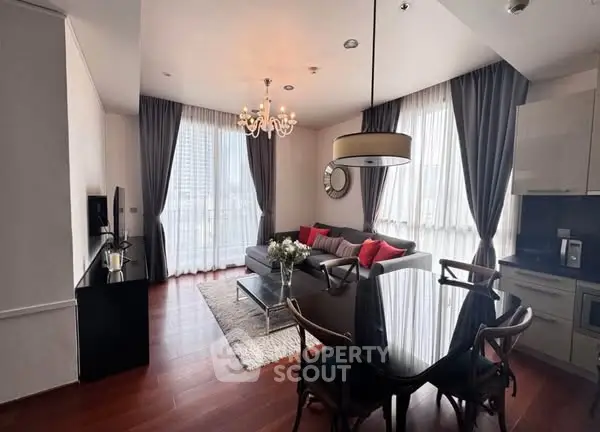Elegant living room with modern decor and large windows in a high-rise apartment.
