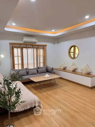 Modern living room with stylish furniture and wooden flooring