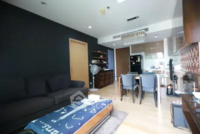 Modern living room with open kitchen, stylish decor, and cozy seating area in a contemporary apartment.