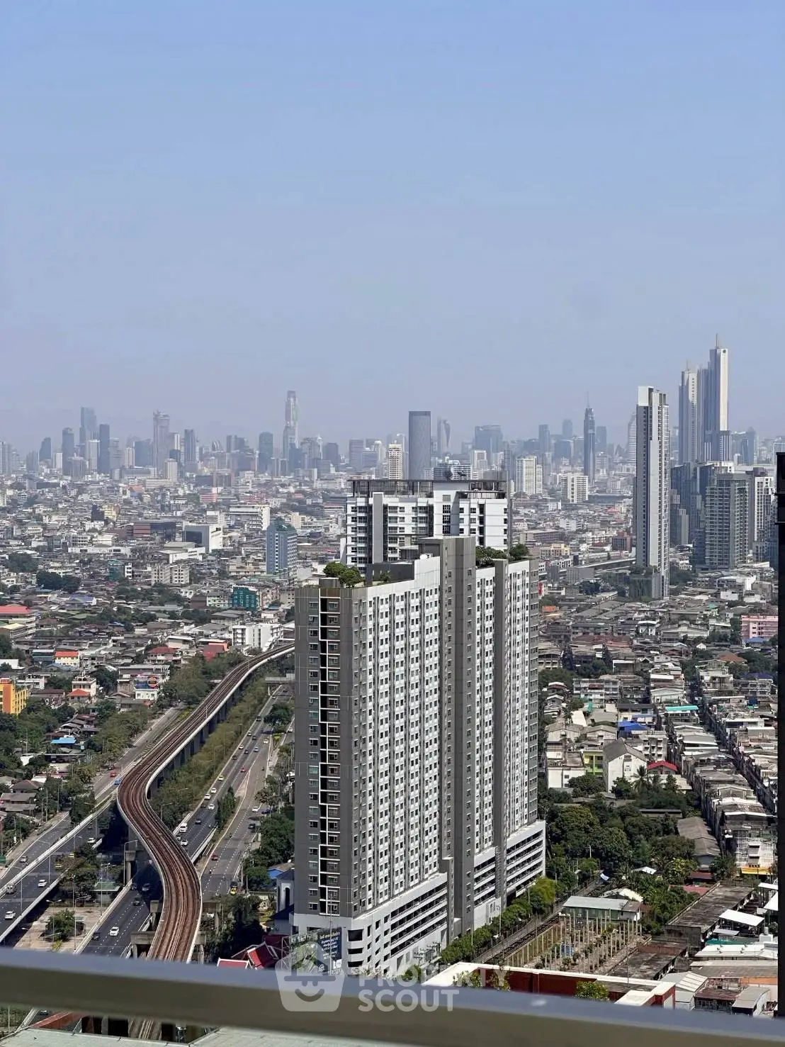 Stunning cityscape view with modern high-rise building and urban skyline, perfect for real estate investment.