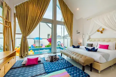 Luxurious bedroom with pool view and elegant decor in modern home