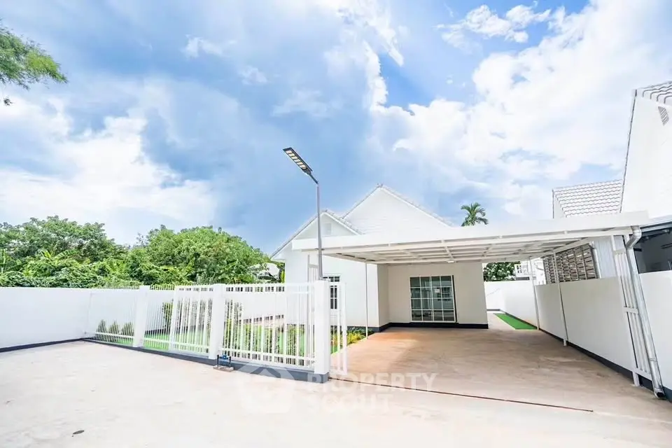 Spacious modern home with large driveway and covered parking area.