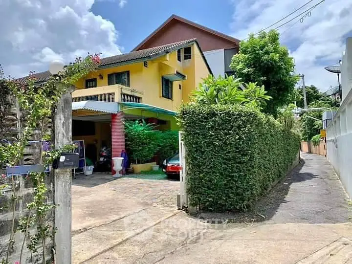 Charming suburban house with lush greenery and spacious driveway