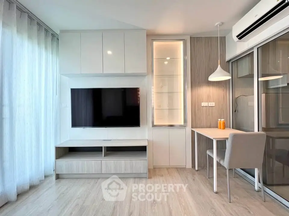 Modern living room with sleek TV setup and stylish workspace