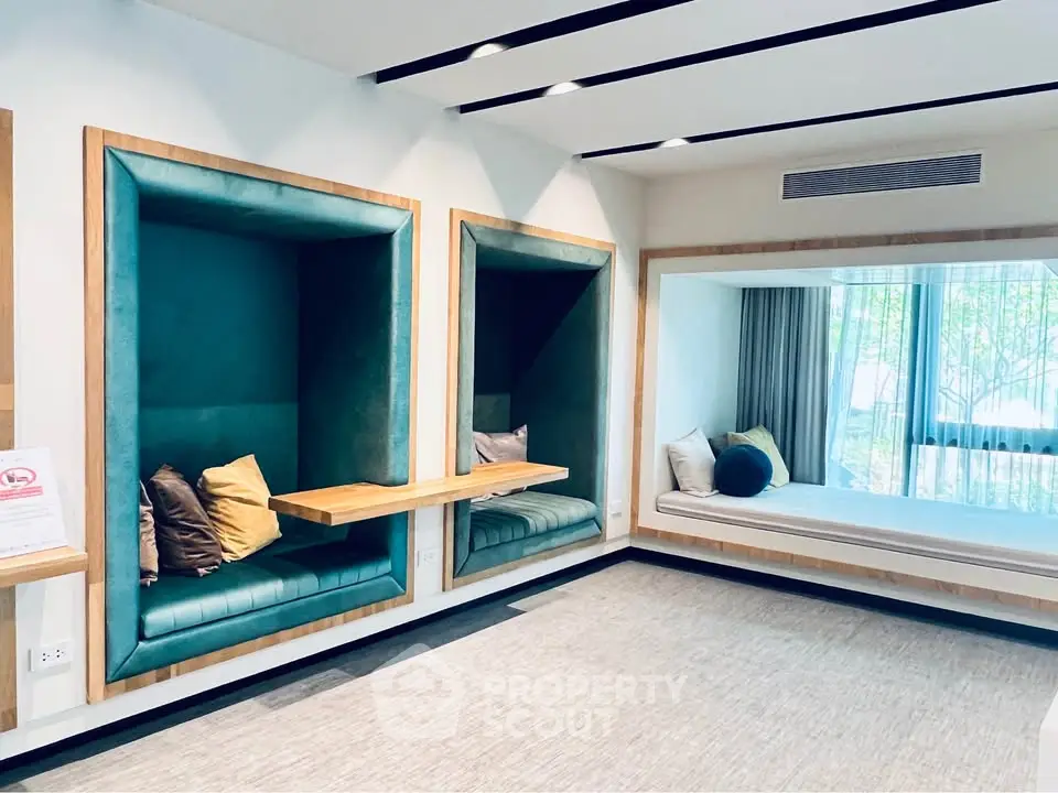 Modern living room with unique built-in seating and large window view.