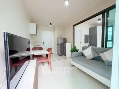 Modern living room with open layout, stylish furniture, and natural light in a contemporary apartment.