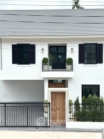Modern two-story house with sleek design and gated entrance